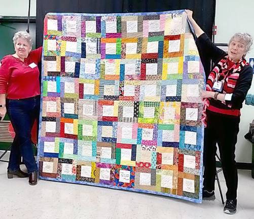 President Mary Kirchoff (right) was gifted a signature quilt from the members as thanks for her service. She is pictured with Janet Miller.