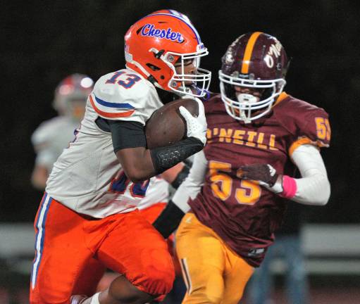 Running Back Bryce Caldwell (#13) runs the ball with Shea Jerke #53 of O’Neill in pursuit.