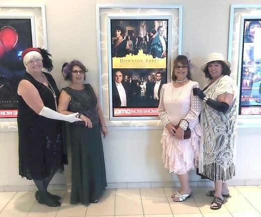 At the theater, posed at the Downton Abbey movie poster (from left): Kathy Brogan, Barbara Morrison, Mary Smith, and Barbara Bauer
