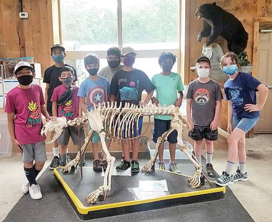 It's not often you see a young man place his hand atop that of skeletal remains with the casual but familiar affectiion he might show a dog or cat. But these are Junior Naturalists (entering 5th or 6th grade) enjoying the EcoZone at the Pocono Environmental Education Center’s Nature Day Camp. Provided photo.