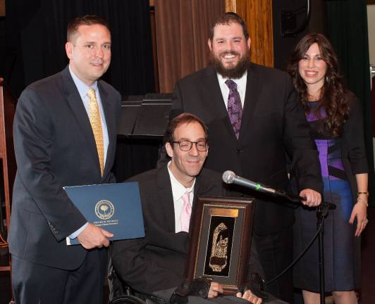 Chabad Honoree Eric Muhlrad of Chester receives the Tikkun Olam Award. Pictured with Rabbi Pesach and Chana Burston and County Executive Steve Neuhaus