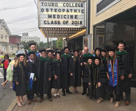 Provided photo Members of the first graduating class of Touro College of Osteopathic Medicine in Middletown at the Paramount Theater with Dr. Alex Joanow, director of clinical rotations and an adjunct clinical assistant professor in the Department of Osteopathic and Manipulative Medicine at the school.