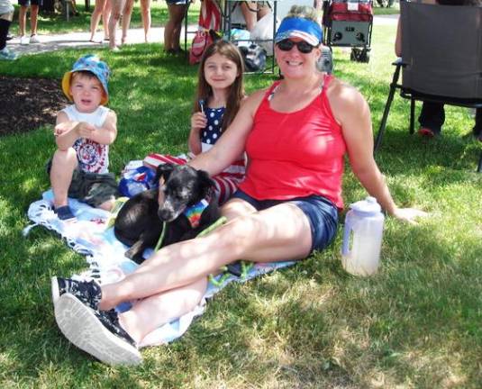 Goshenites Caitlin Jensen, with her children Madelyn, 7, and Jackson, 3 1/2, and their dog, Shelby, enjoy the parade. Her other two children, Joseph, 6, and Jonathan, 8, marched in the parade with their Little League baseball team.