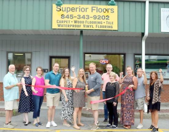 On Thursday, July1, Florida Deputy Mayor Tom Fuller (left) and members of the Warwick Valley Chamber of Commerce joined owner Paul Gardiner (center), his family, friends and staff to celebrate the firm’s recently opened showroom at 133 N. Main St. in the Village of Florida. Photo by Roger Gavan.