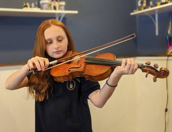 Payton Iadarola, 11, with her new Eastman violin.