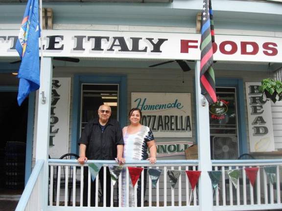 Peter Scalia and his daughter Aurelia Scalia on the front porch of Little Italy Foods, located at 87 Main St. in the Village of Goshen. The deli is open 7 a.m. until 8 p.m. Monday through Saturday. Photo by Geri Corey.