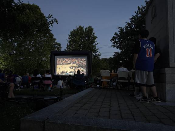 The crowd watching the first quarter as the sun set.
