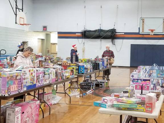 Kiwanians sorting toys before packing them up for families who had registered for Toyland.