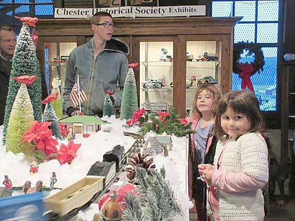 Kayla Smith and Julianna Small admire the model train at last year's tree lighting (Photo by Ginny Privitar)
