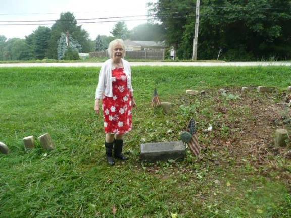 Christina McCawley next to now-cleared grave of Horace Pippin, thanks in large part to her efforts. Photo by Dwight McCawley.