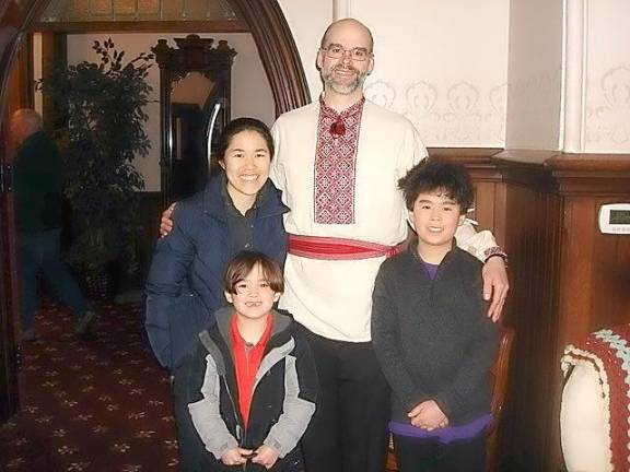 Elder Robert Person, clad in traditional Ukrainian dress, with his wife, Christine Chen-Person, and