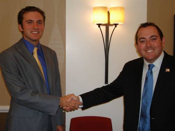 Woodbury Supervisor James Skoufis, left, shakes hands with Goshen Mayor Kyle Roddey, competitors for the New York Assembly's 99th District, at a recent Goshen Chamber of Commerce forum (Photo by Geri Corey)
