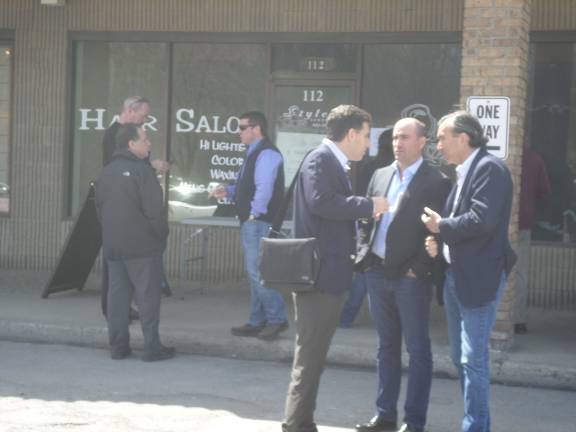 Members of Goshen Plaza Partners, right, who hold the mortgage on the plaza, confer after they lost a bid to takeover the property at an auction held at the plaza on Wednesday afternoon. (Photo by Nathan Mayberg)