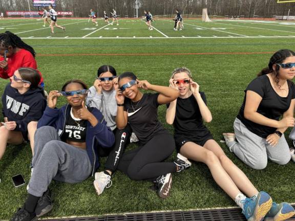 Faculty, staff, and several students took to the athletic fields to observe the celestial event.