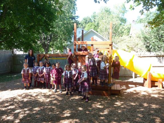 Alyssa Kuehner (left) with the 2014-15 Kindergarten class at St. John (Photo provided)