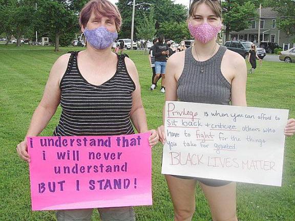 Protester Skylar Miller, on the right, held a sign that read: “Privilege is when you can afford to sit back and criticize others who have to fight for the things you take for granted. BLACK LIVES MATTER.” She stands with her mother, Evelyn, who said, “I totally support what my daughter said.” Both live in Goshen. Photo by Geri Corey.