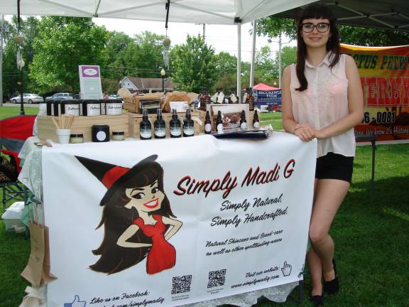Madison Gueits, owner of Simply Madi G, is happy to discuss her handcrafted skin care products at the farmers market. &#x201c;People feel love when they touch my products,&#x201d; she said. (Photo by Geri Corey)