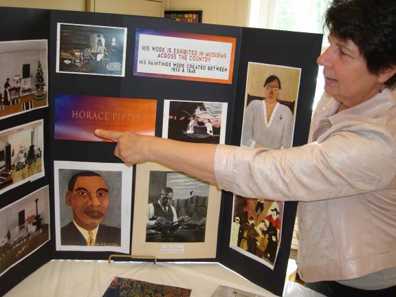 Elaine McClung talks about the paintings of known artist, Horace Pippin, who grew up in Goshen (Photo by Geri Corey)