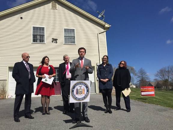Photos from Facebook Assemblyman James Skoufis at a press conference at a "zombie property" in Washingtonville, where the house had been stuck in the foreclosure process for three years.