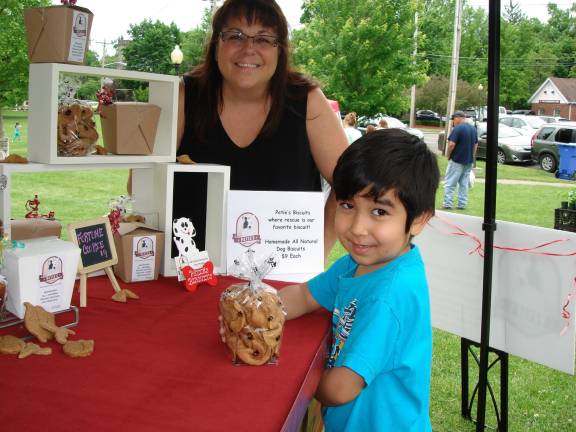 Five-year old Mack Stank from Unionville is hoping to get a puppy so that he can buy dog treats from Petie&#x2019;s Biscuit. He's pictured with owner Christa Falasca (Photo by Geri Corey)