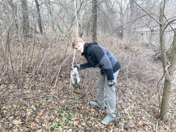 Caleb Garver, 16, picks up trash