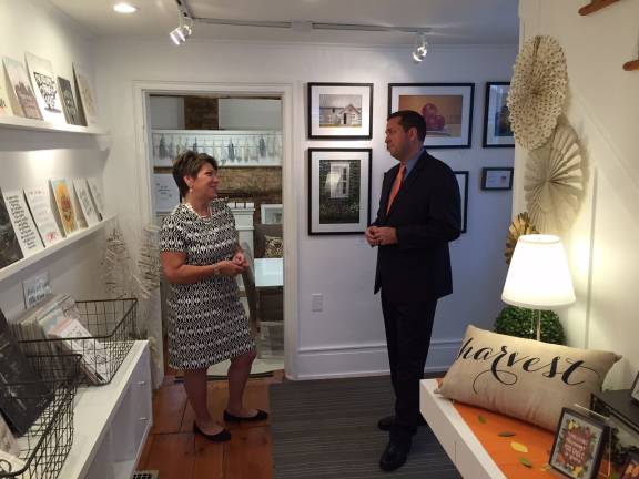 Orange County Executive Steven M. Neuhaus talks to Kat Parrella, owner and designer of Merrily Paper in Sugar Loaf, at her studio as part of his "Open for Business" initiative.