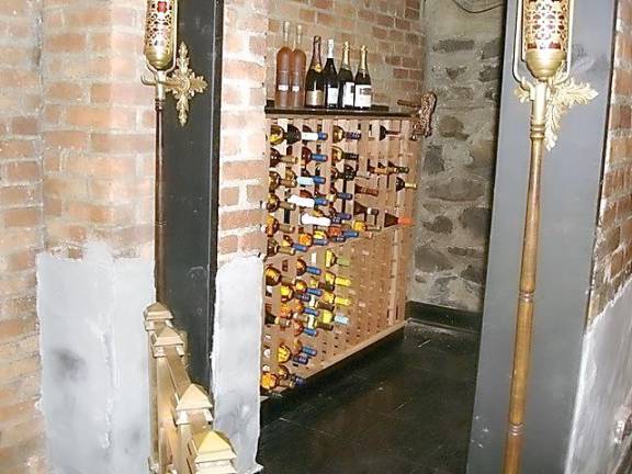 The brick and stone wine cellar in the basement of the Novellino house contained a bar and sitting area along with wine storage.
