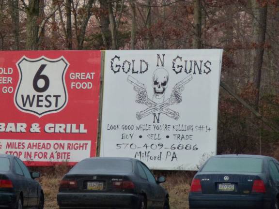 This billboard on Route 6 in Milford, Pa., advertises the Gold-n-Guns shop with the motto: &quot;Look good while you're killing!&quot; (Photo by Pamela Chergotis)