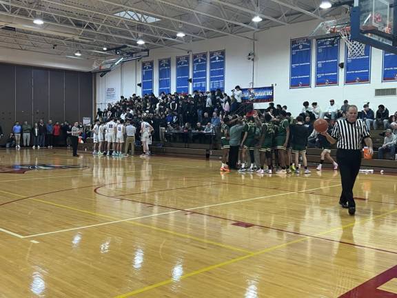 Teams huddle during a time-out at Goshen High School Varsity Basketball’s first playoff game of the season against FDR High School. Photo: Anastasia Manouvelos