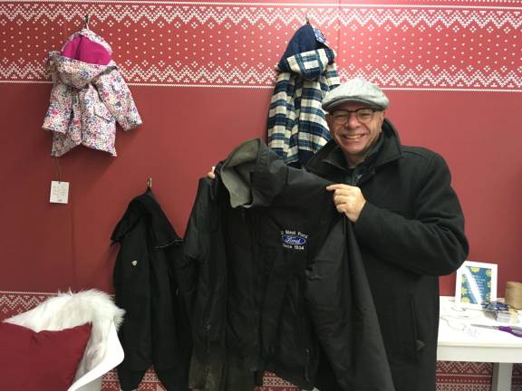 Joe Preston holds up one of the coats he donated at the Union Square pop-up shop on Tuesday. Photo: Megan Conn