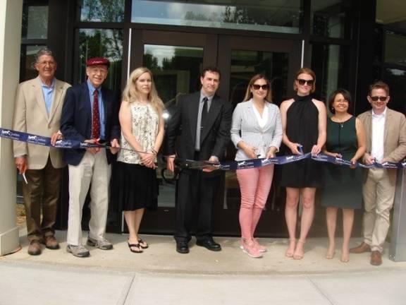 Bernard Marone (center), president of the board of trustees of the Goshen Public Library and Historical Society, is prepared to cut the ribbon. He&#x2019;s flanked by board and committee members, with library director Matthew Gomm on the far right. (Photo by Geri Corey)