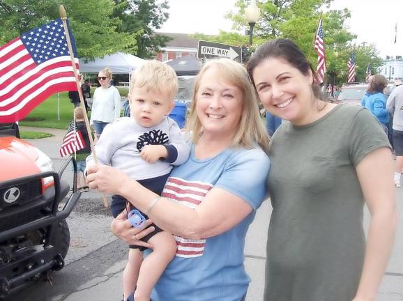 Many onlookers came to the parade to support the heroes who helped the community throughout the pandemic. Nineteen-month-old Jalen, waving his flag, came with his grandmother, Julie Turi, and his mother Mari. Jalen is the son of Mari and Nick Turi.