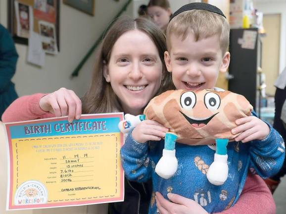 Michelle Sentell and her son Jacob, 4, of Monroe, create a “Challah friend” along with a birth certificate at Chabad of Orange County’s Loaves of Love.