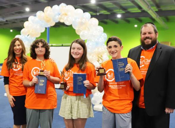 Chabad Hebrew School graduates (l-r) Fiana Goldenberg of Warwick, Ruby Eberly of Monroe, and Shepard Hoffman of Goshen display their personalized prayer books and trophies with school directors Chana Burston and Rabbi Pesach.