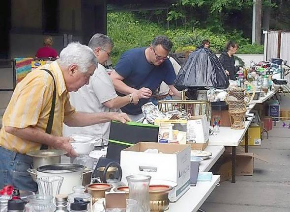 Visitors search through table after table of good at the Chester Historical Society’s 2018 yard sale at the 1915 Erie Station Museum on Winkler Place downtown. The Yard Sale returns this year on Saturday, Sept. 18. Photo source: www.chesterhistoricalsociety.com/photos/2018.