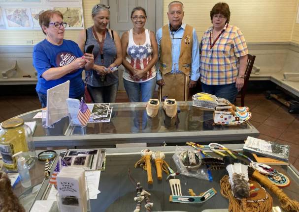 Pictured from left to right: Susan Bahren, member of Chester Historical Society; Margaret Howard, Joyce Gamble and Dennis DeFreese, members of the Lenape Tribe; and Judith Barry, member Chester Historical Society, look over some of the items that will be on display during the Chester Historical Society Program on Aug. 26. Photo provided by the Chester Historical Society.