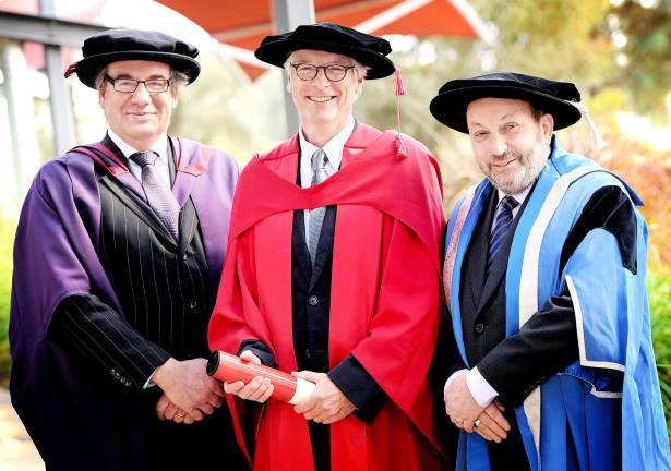 Photo courtesy of Sunraysia Daily Mildura Writers Festival artistic director Paul Kane (center) with Pro Vice-Chancellor Richard Speed (left) and acting Vice-Chancellor John Rosenberg (right) of La Trobe University.&#xfe;&#xc4;&#xf9; Kane, the Orange County Poet Laureate from Warwick, was recently awarded an honorary doctorate from the Australian University.
