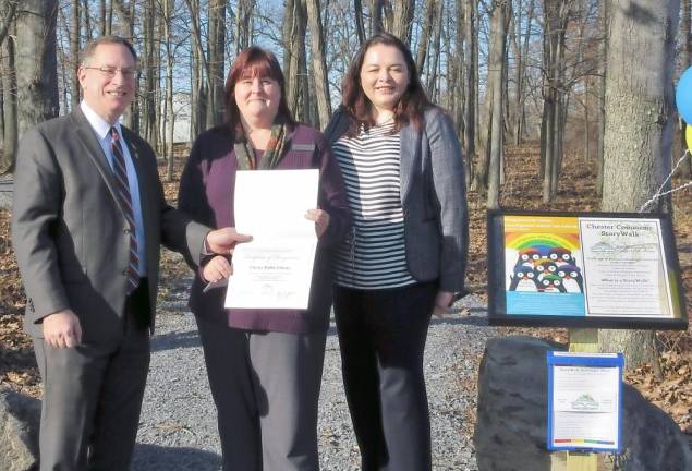 Orange County Legislator Mike Anagnostakis presents a citation to Maureen Jagos, director of the Chester Public Library, and Grace Riario, executive director of the Ramapo Catskill Library System
