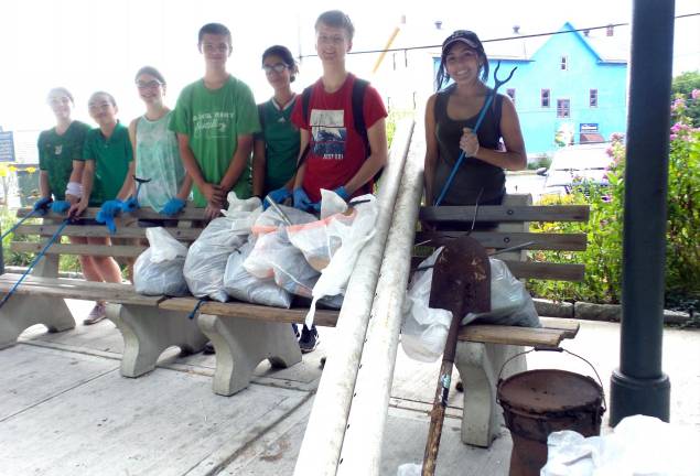 Brenna Lawson, Xuan Chen, Laura Edwards, Jacob Mott, Ekhine Avalos, Caleb Garver and Sofia Balich with some of the bags of trash and other debris they picked up near the Erie Depot.