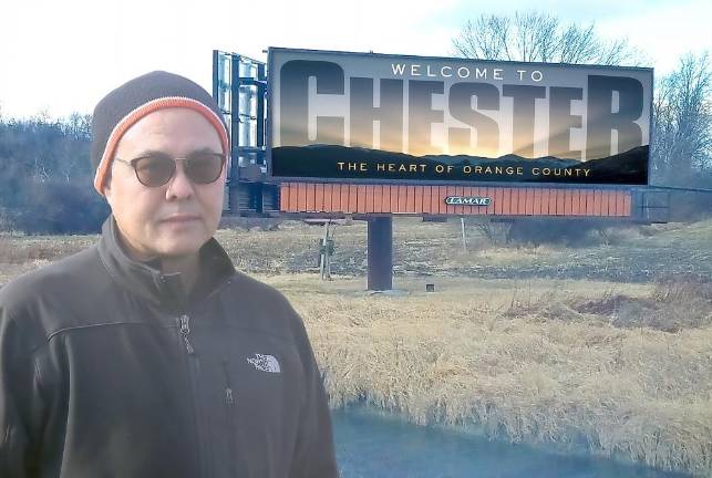 David Stevenson in front of one of the many designs he created for Lamar Co. to use on two billboards in Chester