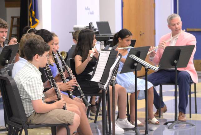Band teacher William Couture plays along with summer band camp students during the program’s ending concert. (Photo provided)