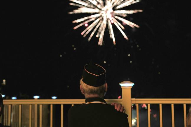 A war veteran watches the fireworks display from the special VIP viewing area outside the golf course restaurant in Thomas Bull Memorial Park.