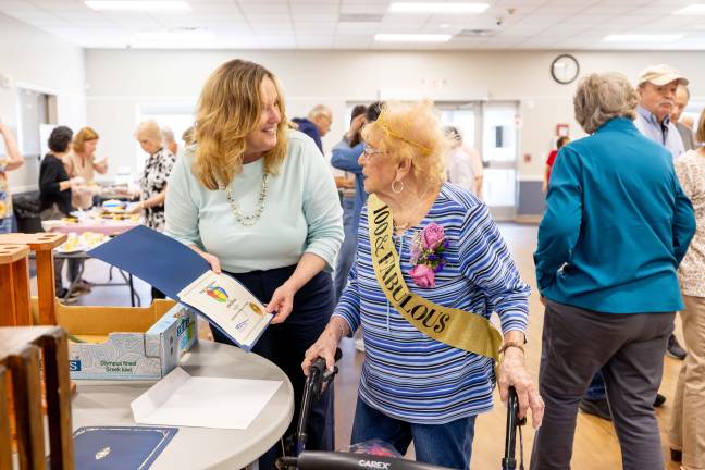 Mary Pat Smith of County Exective Steve Neahaus' office presented Sophie Halstead with recognition award as she celebrated her 100th birthday at the Senior Center in Chester.