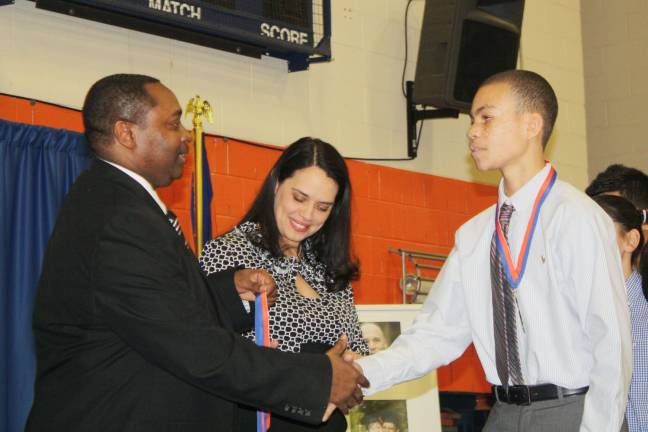 Theodore Riley shakes hands with SUNY Orange Vice President of Student Services Paul Broadie II.