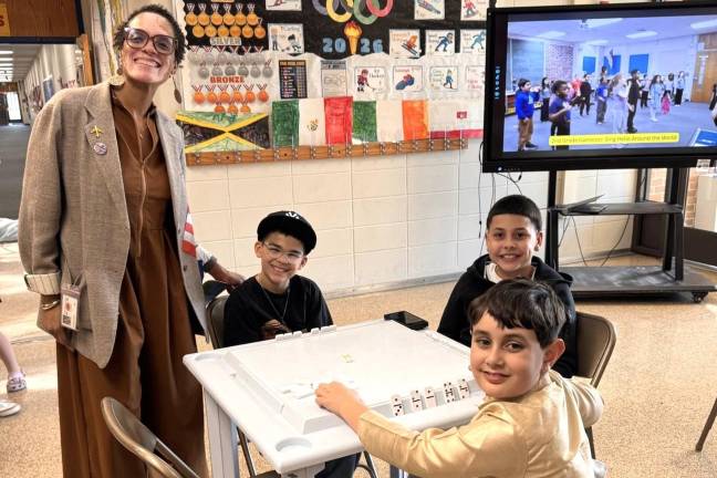 Dayanara Garcia, Chester’s director of curriculum, instruction and communication, hosted an interactive table where guests could learn to play dominoes.