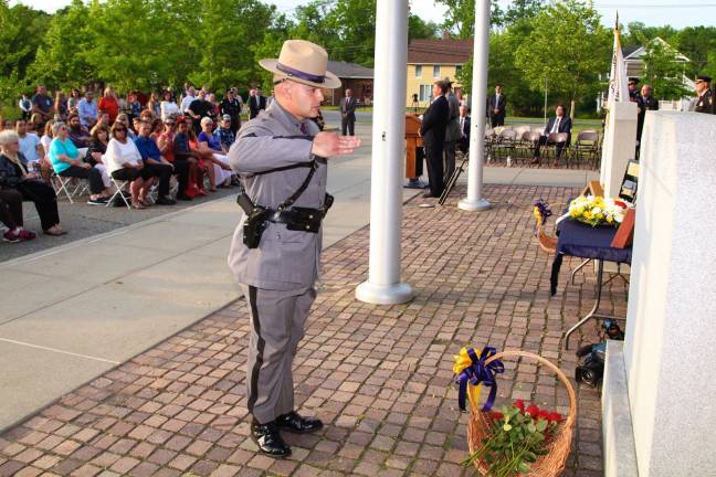 A New York State Police trooper pays homage to the memory of the members of the Orange County law enforcement community who made the ultimate sacrifice during last year's memorial service in Goshen. This year's memorial will be held May 5.