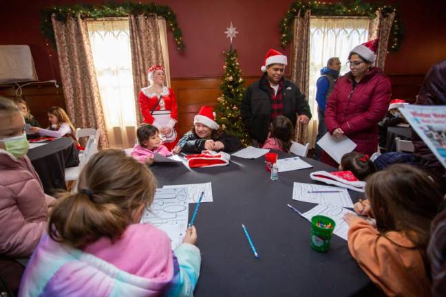 Mrs. Claus helping local kids write letters to give to Santa.