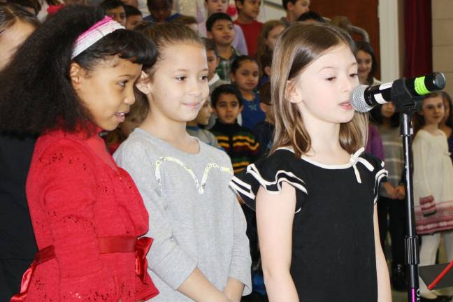 Essence Vega and Nevaeh Warner watch as Ava DiGrandi addresses the crowd.