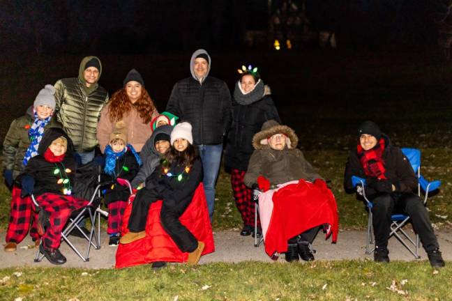 Local families watch the parade from the sidelines, of Holiday Light Parade in Chester, NY. Photos by Sammie Finch