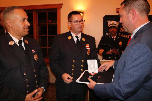 Neuhaus presents City of Newburgh Fire Department Lt. Anthony Muhammad (left) and Acting Chief Terry Ahlers with a Meritorious Service Award (Photo provided)